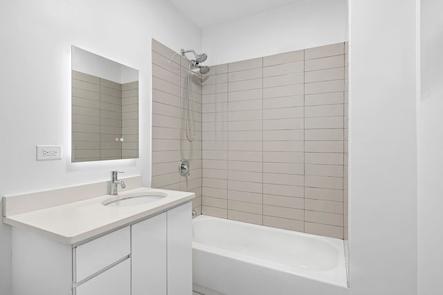 bathroom featuring vanity and tiled shower / bath combo