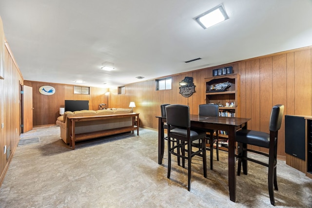 dining room with wooden walls