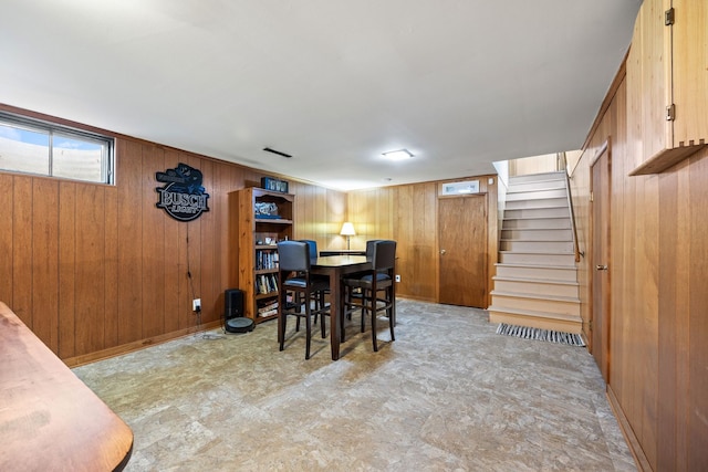 dining room featuring wood walls