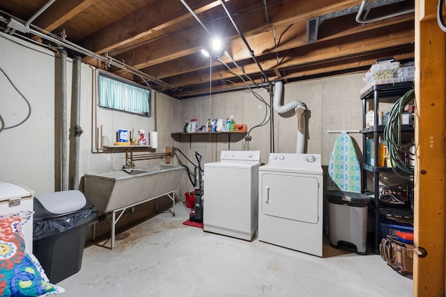 washroom with sink and washing machine and clothes dryer