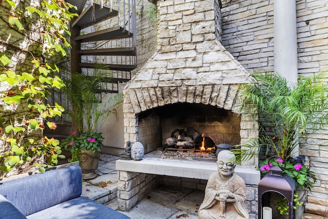 exterior details featuring an outdoor stone fireplace