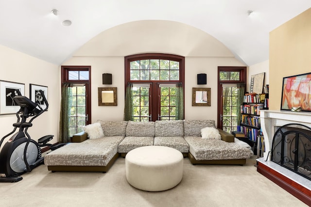 carpeted living room featuring vaulted ceiling