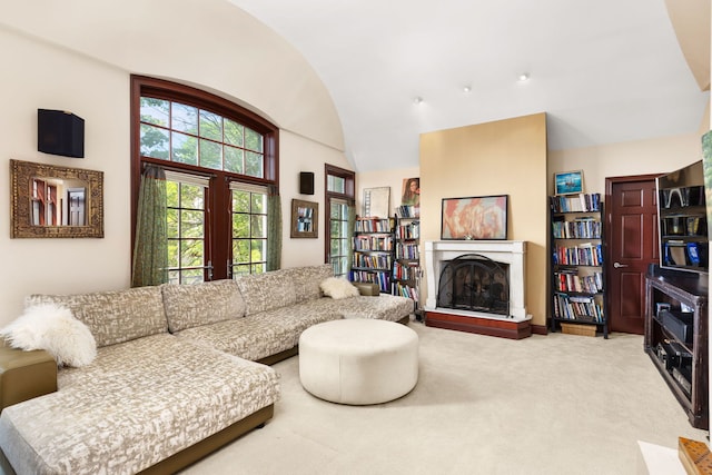 living room featuring carpet and lofted ceiling