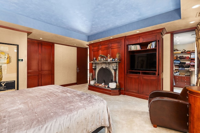 carpeted bedroom with a raised ceiling