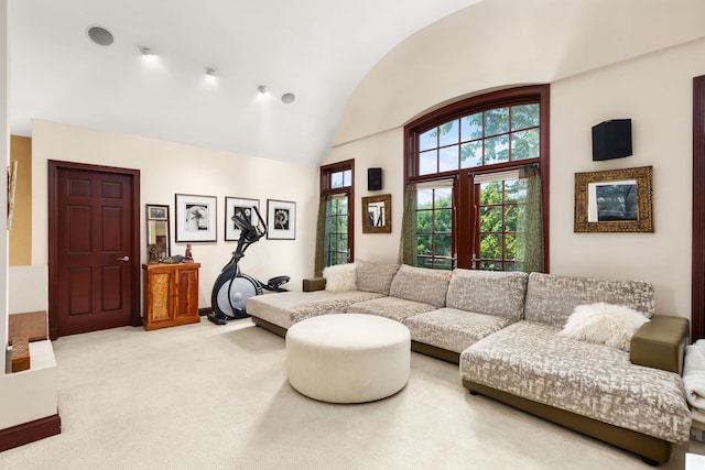 living room featuring lofted ceiling and light carpet