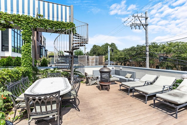 wooden terrace featuring an outdoor fire pit