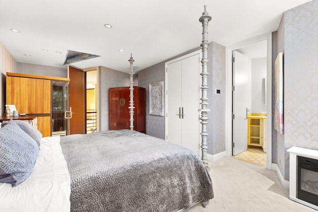 bedroom featuring heating unit and light colored carpet