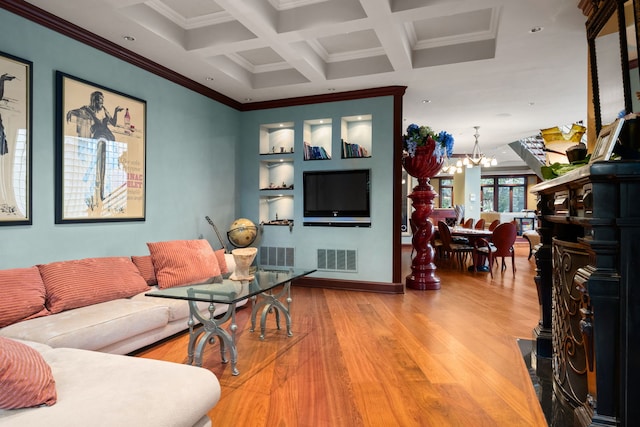 living room with hardwood / wood-style floors, a chandelier, coffered ceiling, beamed ceiling, and crown molding