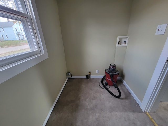 washroom featuring hookup for a washing machine, light colored carpet, and a healthy amount of sunlight