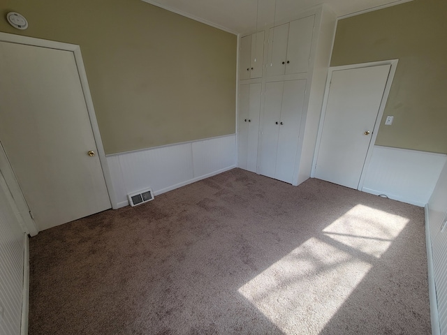 unfurnished bedroom with a closet and carpet flooring