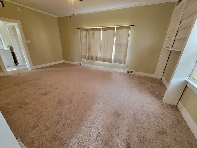 spare room featuring carpet floors and ornamental molding