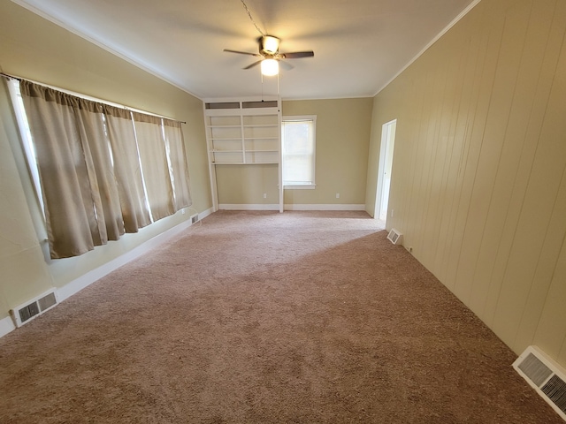 unfurnished room featuring ceiling fan, carpet flooring, and ornamental molding