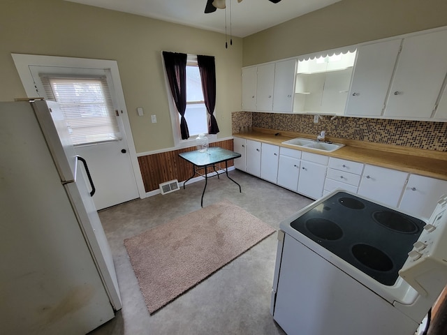 kitchen featuring white cabinets, white appliances, ceiling fan, and sink