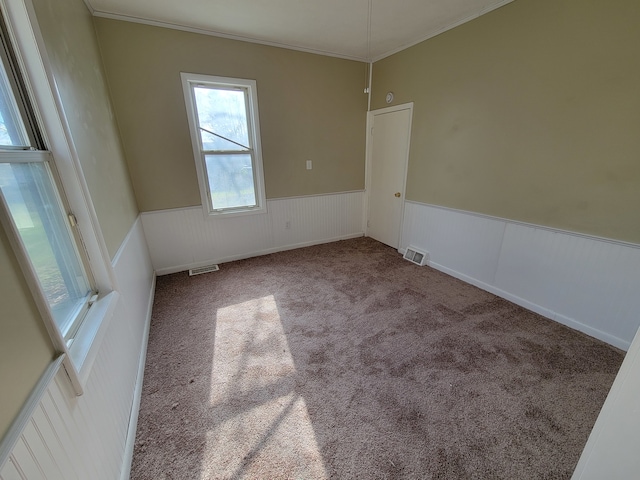 carpeted spare room featuring ornamental molding