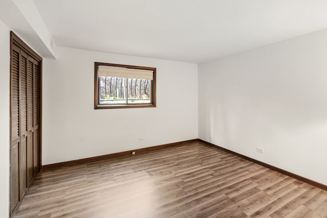 unfurnished bedroom featuring a closet and light wood-type flooring