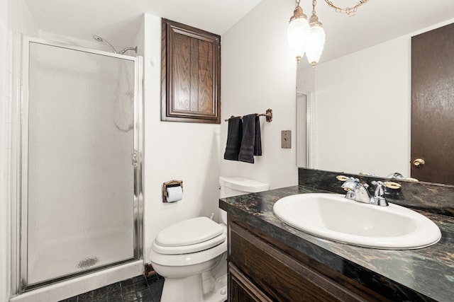 bathroom with vanity, toilet, and a shower with door