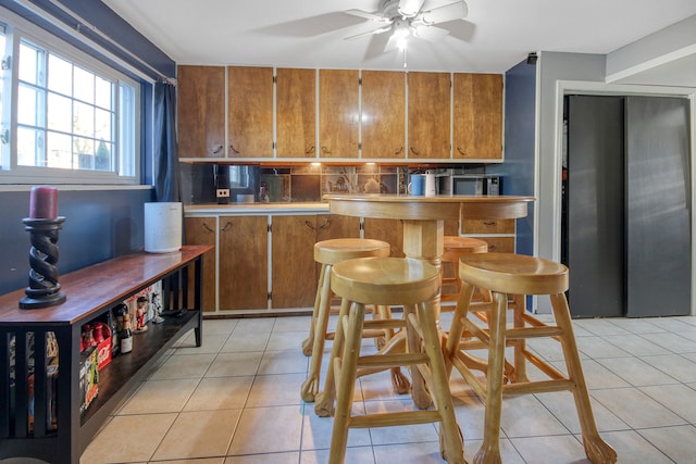 kitchen featuring light tile patterned floors and ceiling fan