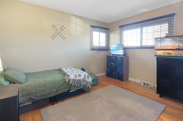 bedroom with hardwood / wood-style flooring