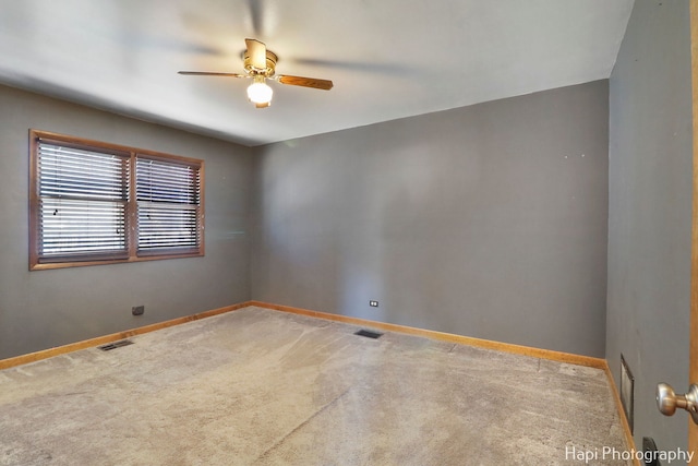 spare room featuring carpet flooring and ceiling fan