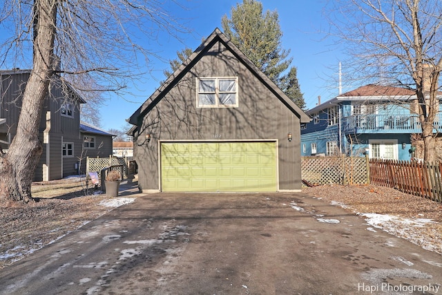 view of front facade featuring a garage and an outdoor structure