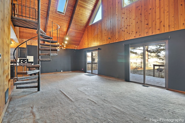 unfurnished living room featuring a wealth of natural light, high vaulted ceiling, beam ceiling, carpet flooring, and wooden ceiling