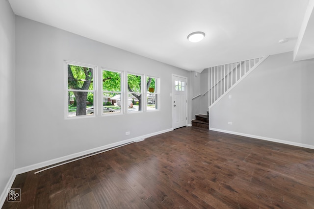 unfurnished living room with dark hardwood / wood-style flooring