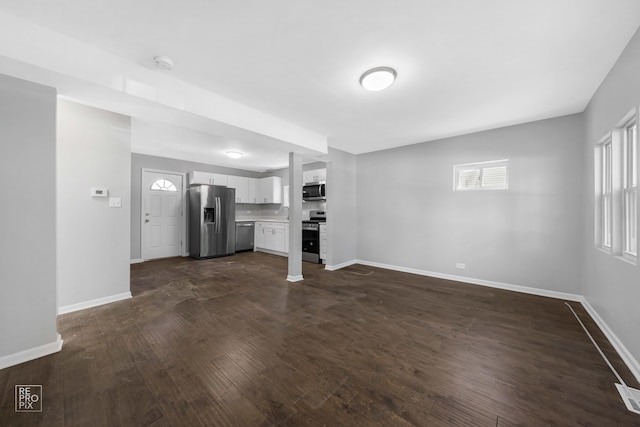 unfurnished living room featuring dark wood-type flooring