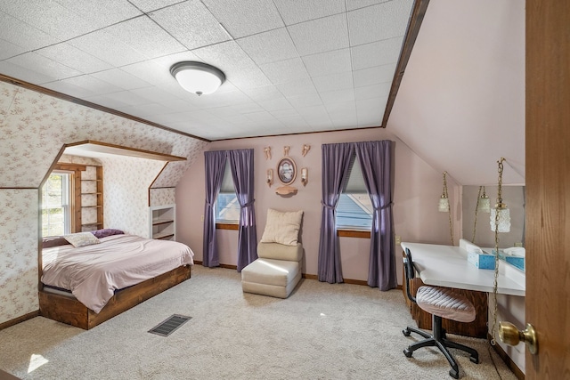 carpeted bedroom with lofted ceiling