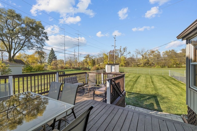 deck with a lawn and a storage shed