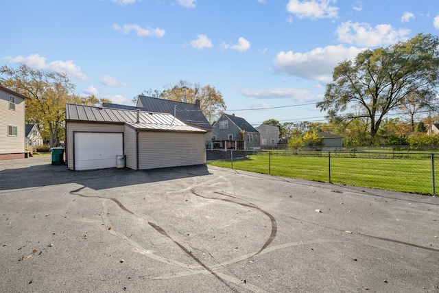 view of front facade with a garage, a front yard, and solar panels