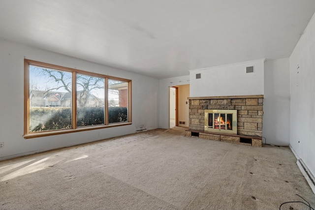 unfurnished living room with a baseboard radiator, light colored carpet, and a fireplace