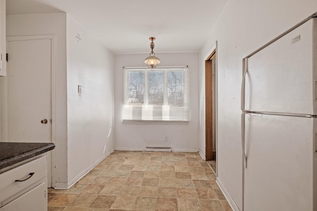 kitchen featuring hanging light fixtures, white cabinetry, white fridge, and baseboard heating