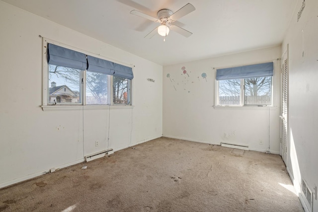 unfurnished room with light carpet, ceiling fan, a healthy amount of sunlight, and baseboard heating