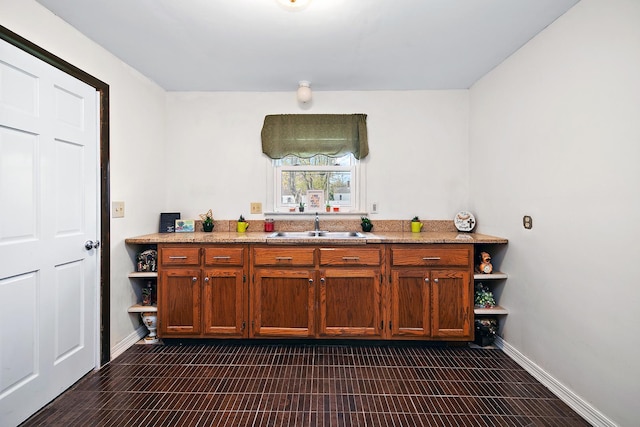 bar with light stone counters and sink