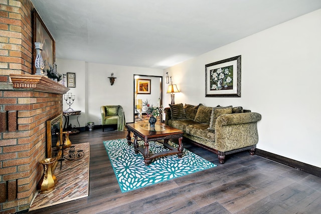 living room featuring dark hardwood / wood-style flooring and a brick fireplace