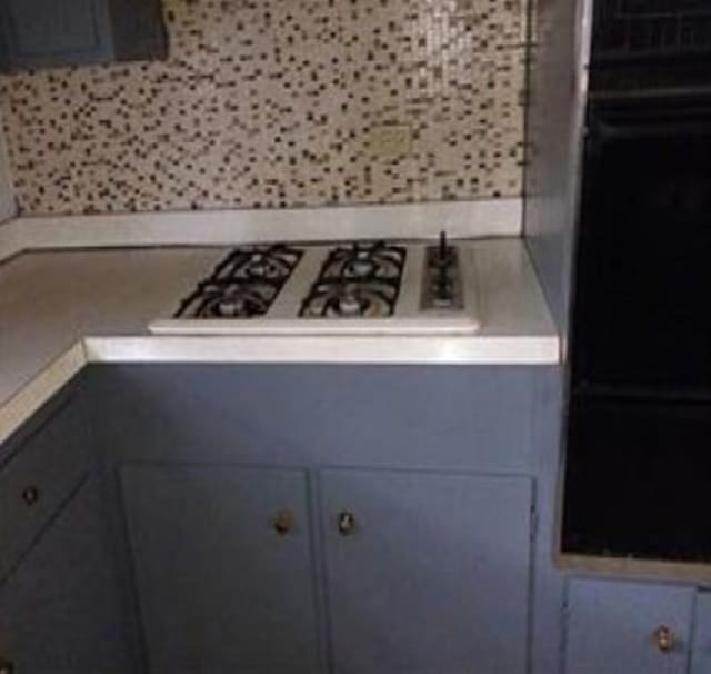 kitchen featuring stainless steel gas cooktop and gray cabinetry