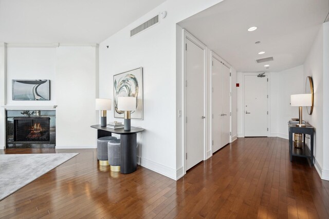 hallway with dark hardwood / wood-style flooring