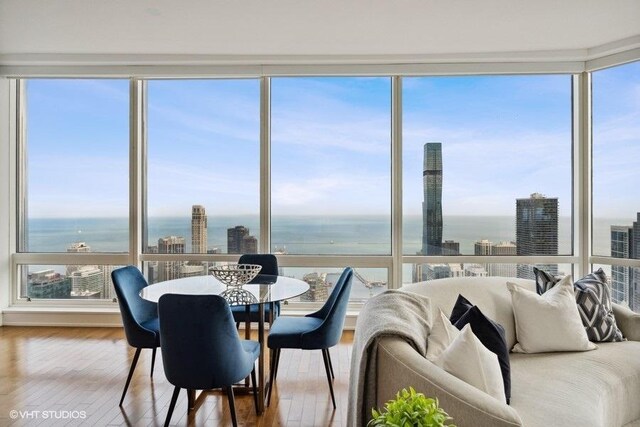 sunroom featuring a water view and plenty of natural light