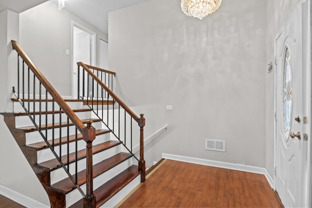 entryway featuring a chandelier and wood-type flooring