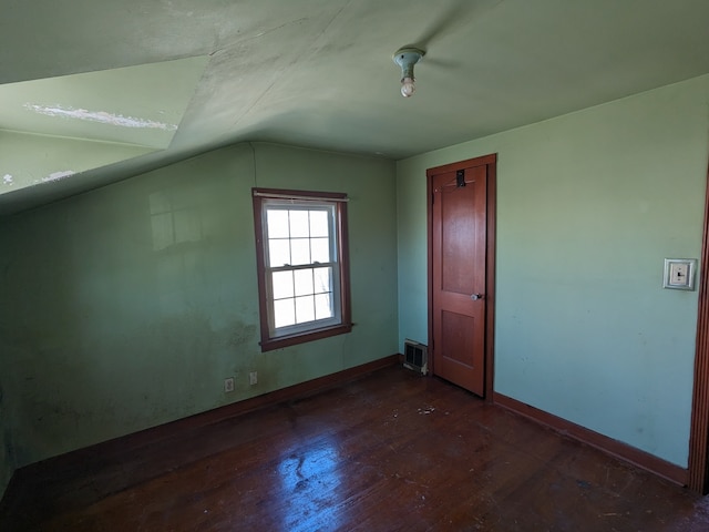 bonus room with vaulted ceiling and dark hardwood / wood-style flooring