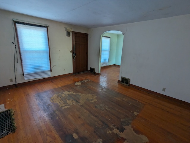 unfurnished room with dark hardwood / wood-style floors