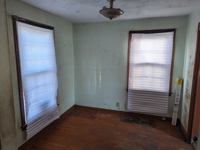 spare room with dark hardwood / wood-style floors