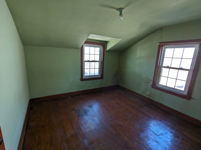 additional living space featuring dark hardwood / wood-style flooring and vaulted ceiling