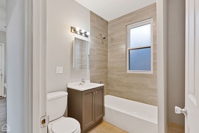 full bathroom featuring tile patterned flooring, vanity, toilet, and tiled shower / bath