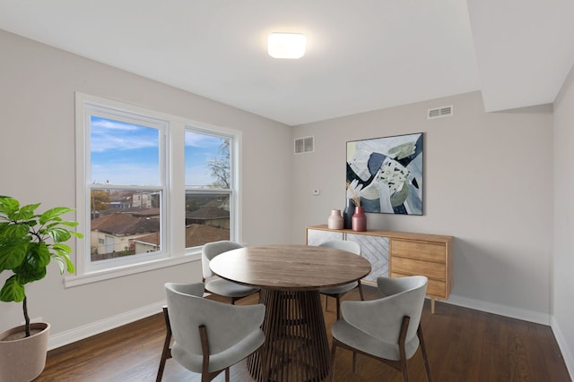 dining area with dark wood-type flooring