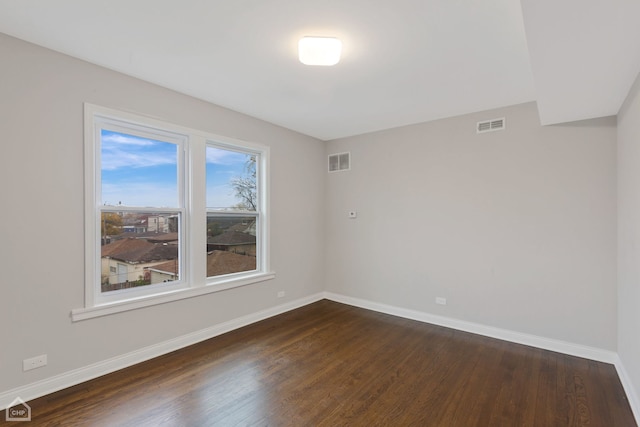 empty room with dark hardwood / wood-style flooring