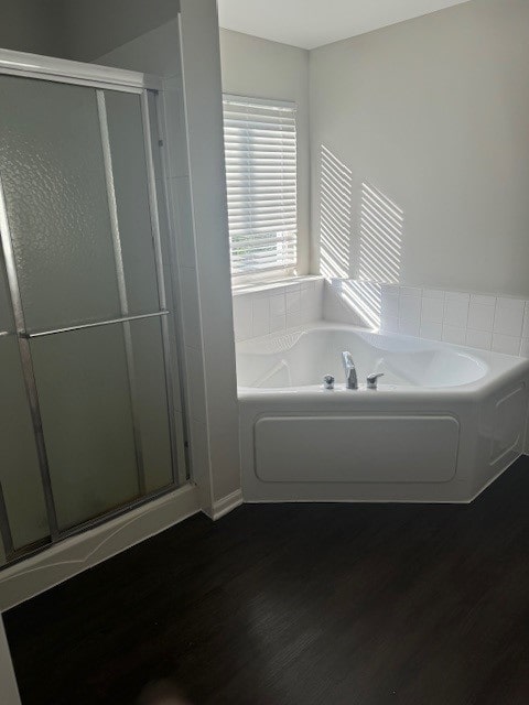 bathroom featuring hardwood / wood-style flooring and independent shower and bath