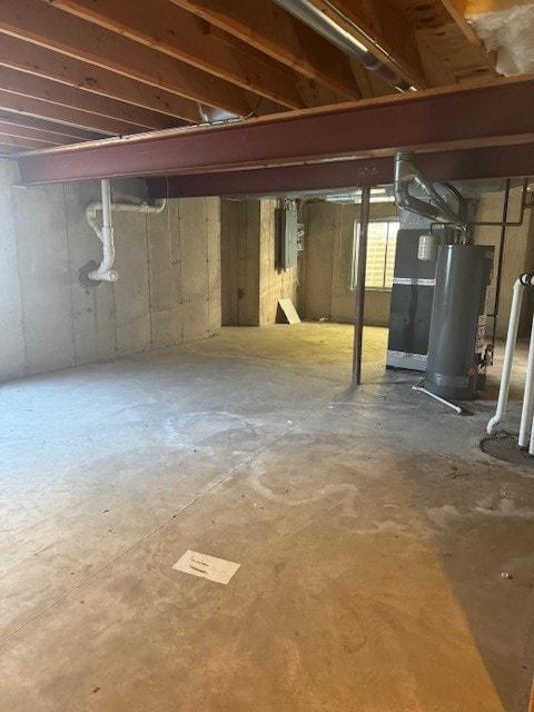 basement featuring water heater, electric panel, and heating unit