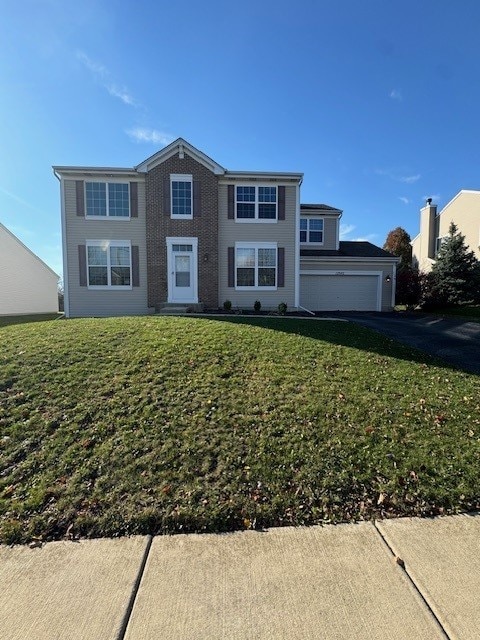 view of front of house with a garage and a front yard