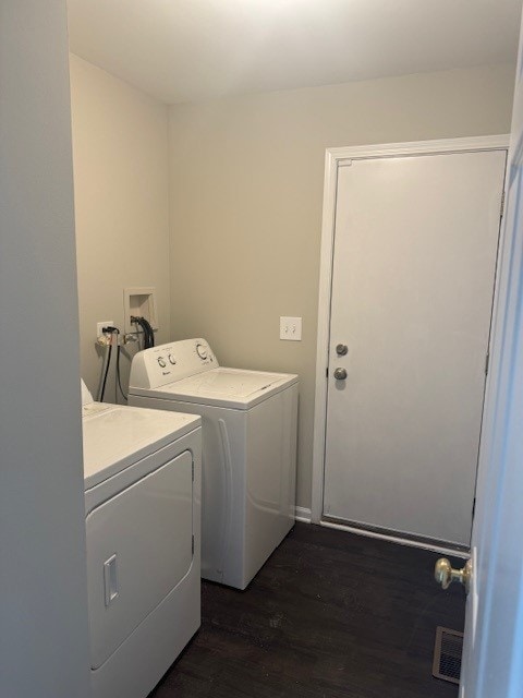 washroom featuring dark wood-type flooring and washer and clothes dryer